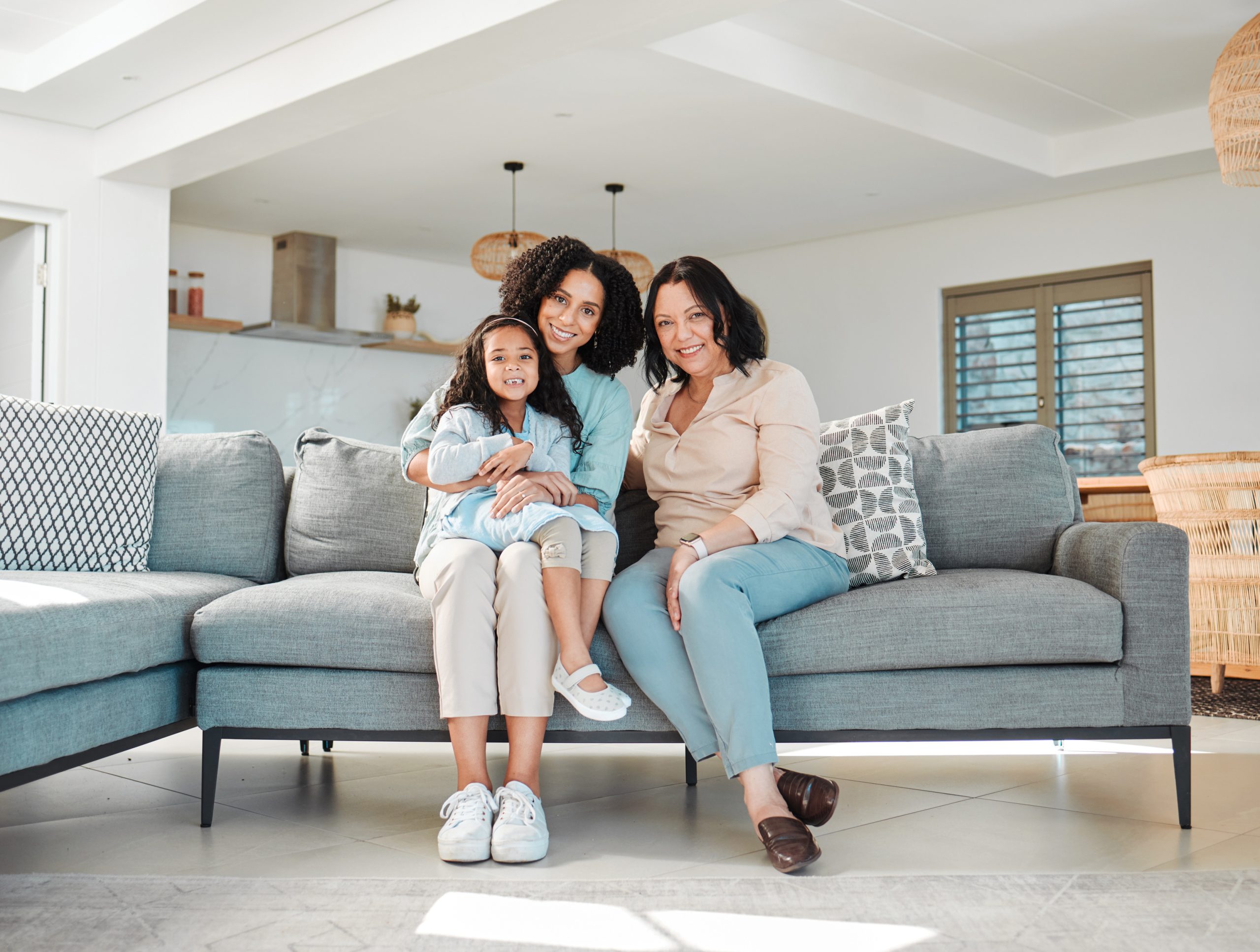 A family sitting together in their home, showcasing the importance of Real Estate Protection Measures and consulting with an Asset Protection attorney to secure their property for future generations.