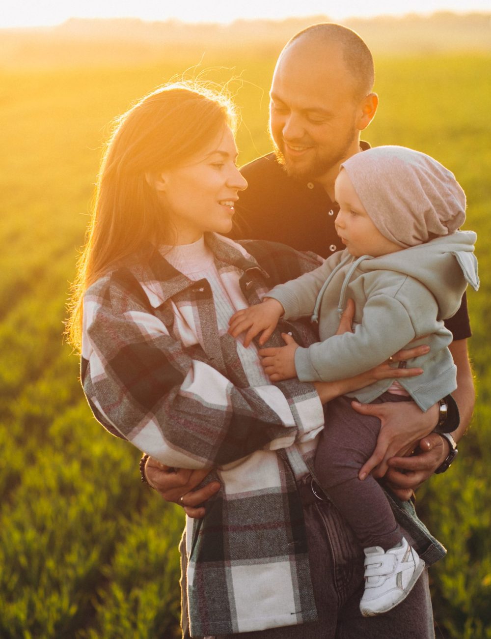 Young family with their kids having fun in the field